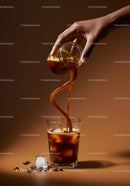 Pouring coffee creamer into iced coffee with coffee beans