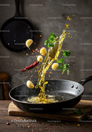 Spices and oil splashing in black frying pan
