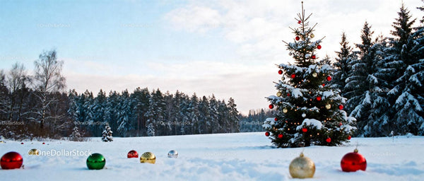 Snowy Christmas tree decorated with red and gold balls