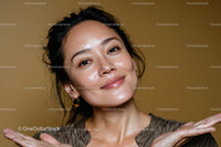 Confident Woman Smiling in Close-Up Portrait with Gold Earrings