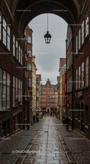 Charming European Old Town Street with Historic Brick Buildings and Cobblestone Path