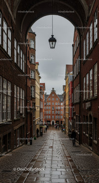 Charming European Old Town Street with Historic Brick Buildings and Cobblestone Path