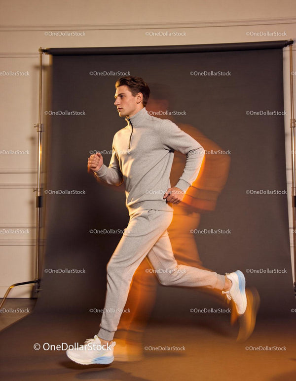 Young man jogging indoors in casual sportswear