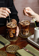 Iced Coffee with Milk Swirls in Stylish Glasses on Modern Cafe Table