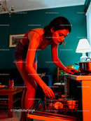 Woman unloading dishwasher in cozy modern kitchen