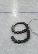Hockey pucks arranged in number nine on ice rink surface