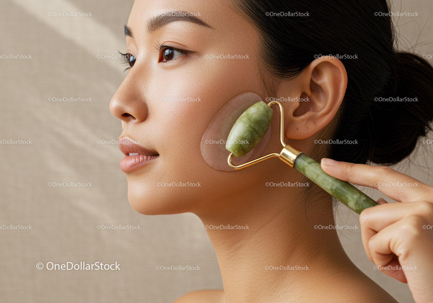 Close Up of Woman Using Jade Roller for Facial Massage and Skincare