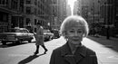 Elderly Woman in Busy City Street Surrounded by Vintage Cars