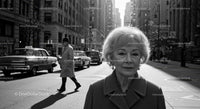 Elderly Woman in Busy City Street Surrounded by Vintage Cars