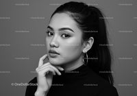 Elegant Black and White Portrait of Fashionable Woman with Hoop Earrings
