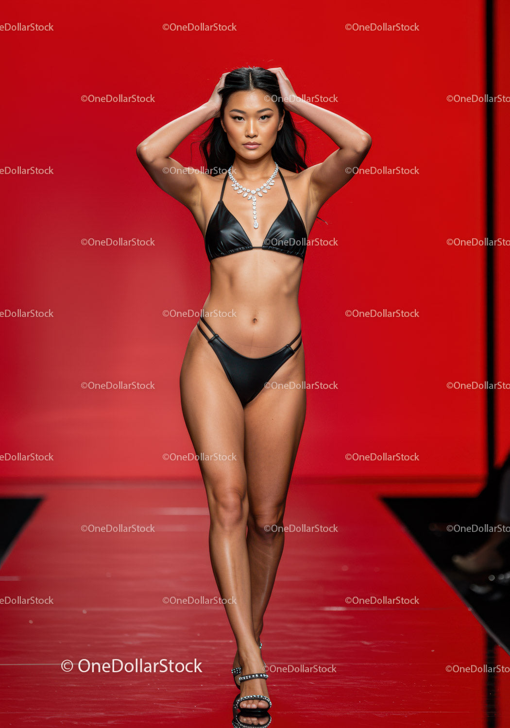 Elegant Female Model Walking on Fashion Runway in Black Bikini