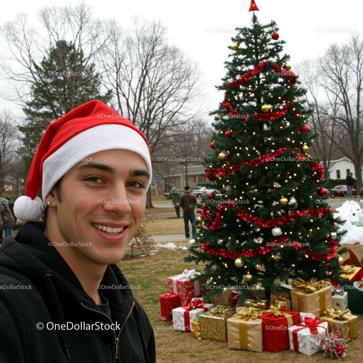 Young man wearing Santa hat with festive Christmas tree