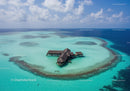Overwater Bungalows on a Tropical Island with Clear Blue Waters