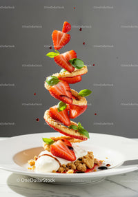 Creative strawberry dessert with cream and fresh basil herbs