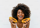 Joyful Woman Holding Fresh Papayas with Bright Smile