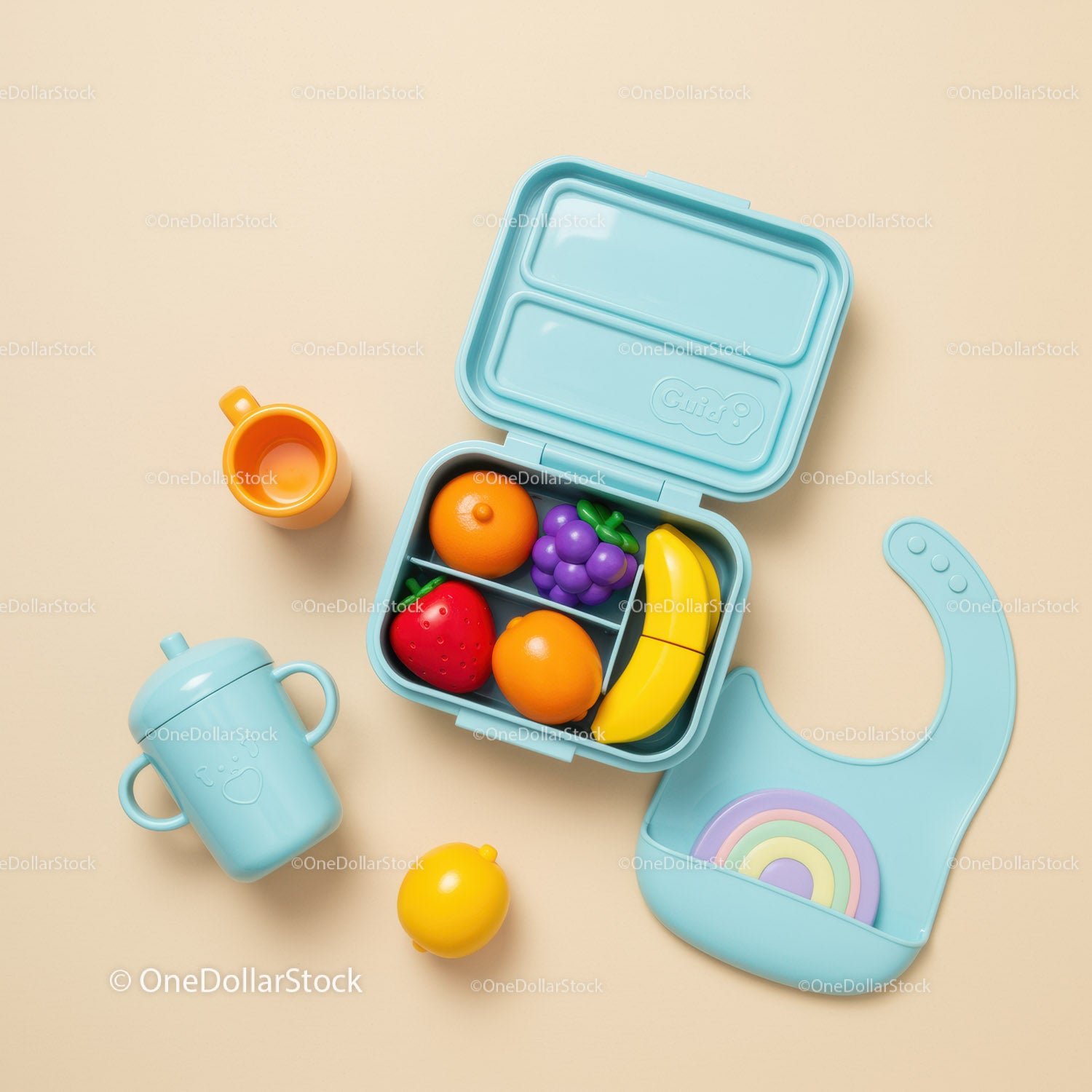 Colorful toddler lunchbox with toy fruit and feeding accessories