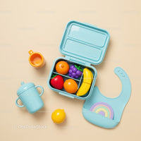 Colorful toddler lunchbox with toy fruit and feeding accessories