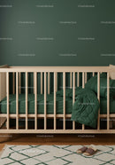 Modern Nursery with Green Bedding and Wooden Bed Frame
