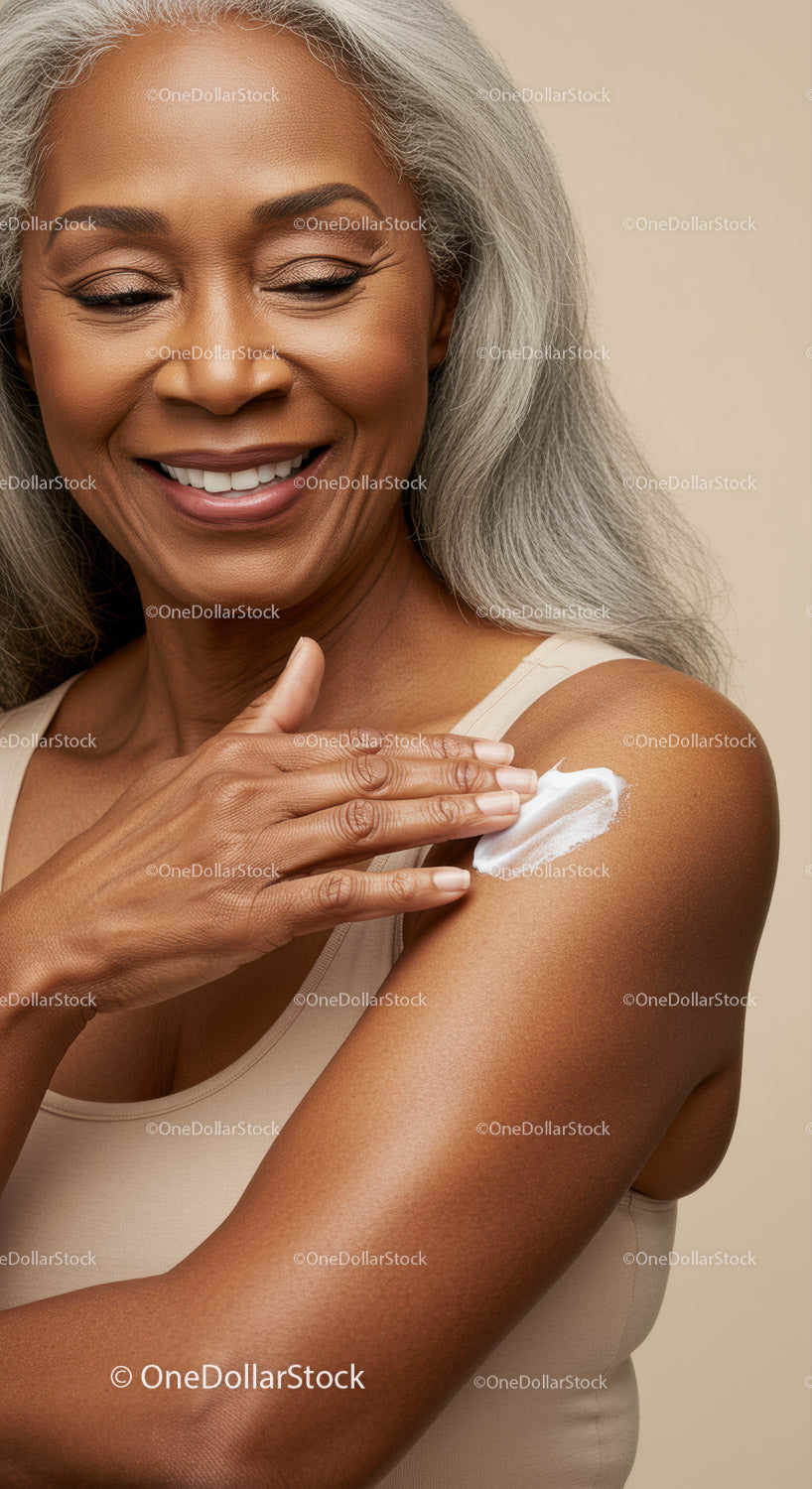 Elderly Woman Applying Moisturizer to Shoulder Smiling Skin Care