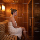 Young Woman Relaxing in Sauna with Wooden Interior