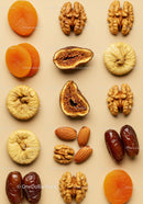 Assorted dried fruits and nuts on beige background