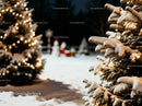 Snow-covered Christmas trees glowing with festive lights