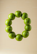 Circle of Fresh Green Limes on Neutral Background