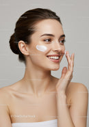 Young Woman Applying Skincare Cream with a Happy Smile