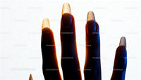Long natural nails glowing in soft backlight