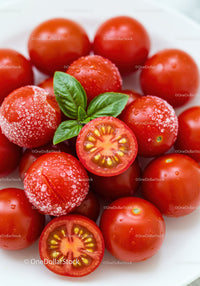 Fresh Cherry Tomatoes with Basil Leaves on White Plate