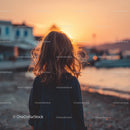 Silhouette of a Child at Sunset by the Ocean Shore