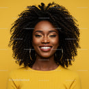 Elegant Woman with Curly Hair and Bright Smile in Yellow Studio Background