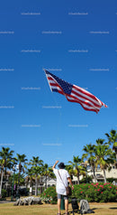 Child Flying American Flag Kite in a Sunny Park Scene
