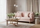 Cozy pastel pink sofa in minimalistic living room interior