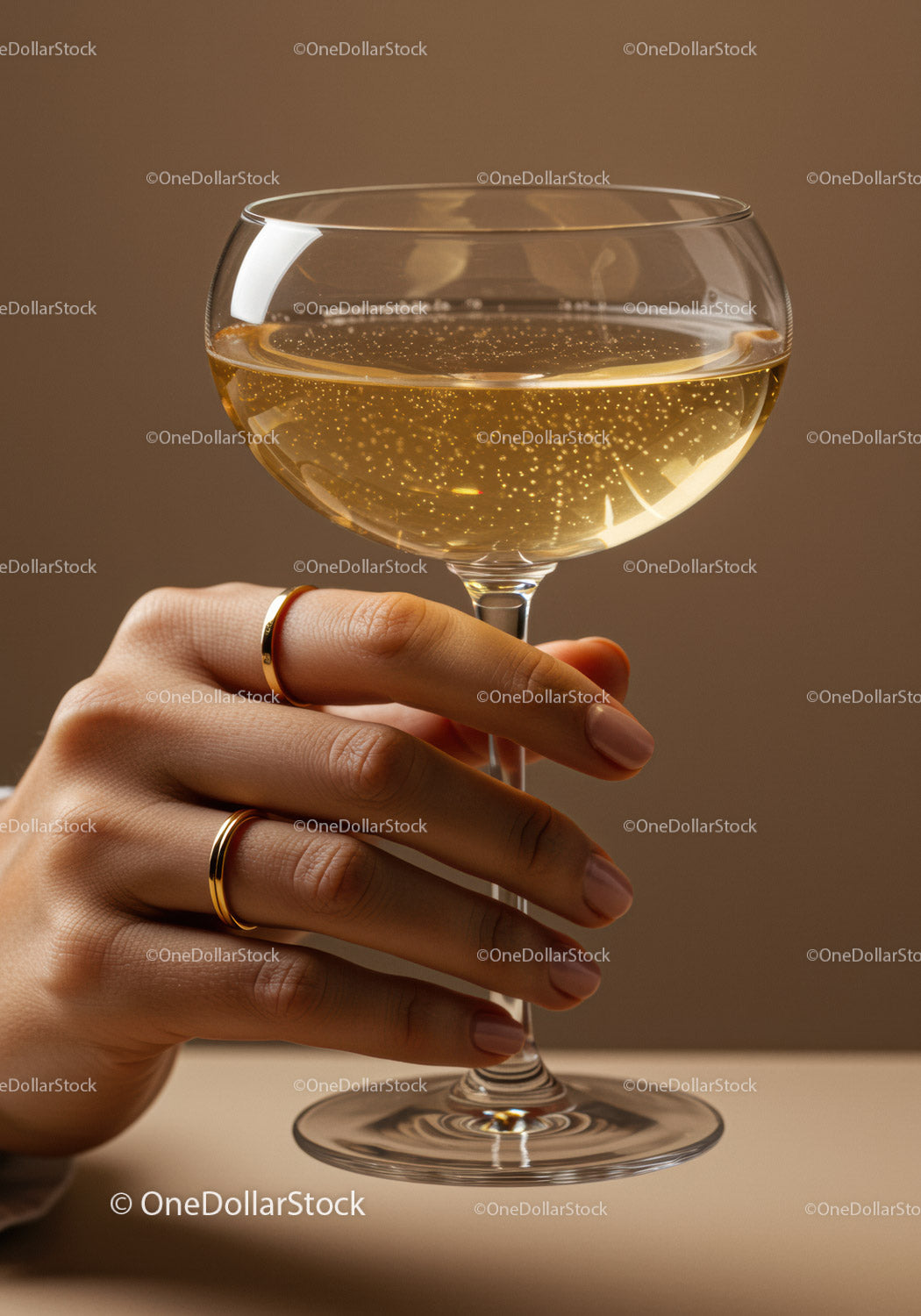 Elegant hand holding sparkling champagne glass close up