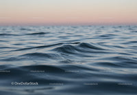 Calm Ocean Waves with Sunset Sky Over Serene Seascape