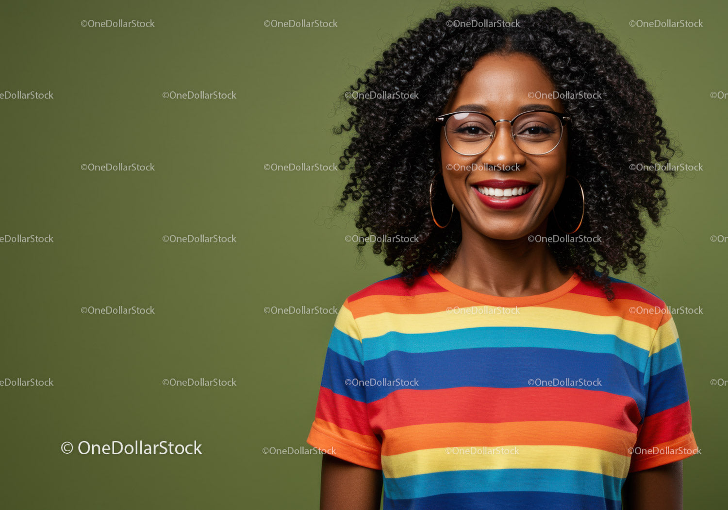 Smiling woman in rainbow striped shirt with curly hair and glasses