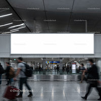 Busy modern airport terminal with blank billboard