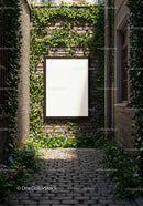 Empty white poster on ivy-covered brick wall alley