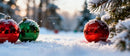 Frosted Christmas Ornaments Resting on Snowy Ground