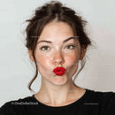 Young Woman with Bright Red Lipstick and Freckles in Studio Portrait