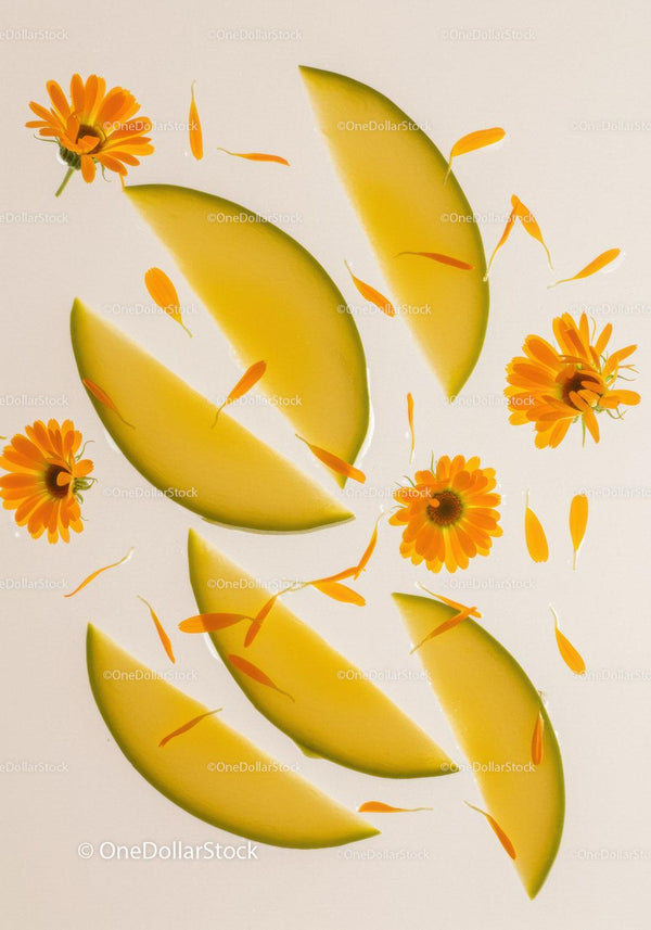 Fresh melon slices with orange calendula flowers and petals