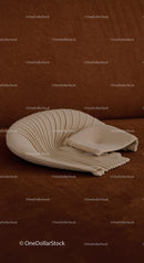 Elegant white ceramic shell sculpture on brown background