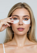 Young Woman Applying Under Eye Patches for Skincare Treatment