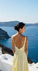 Woman in pale yellow dress enjoying Mediterranean sea view