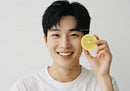 Young Smiling Man Holding Lemon Slice Brightening Facial Expression