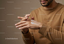 Close-up of Man Applying Hand Moisturizer in Indoor Setting