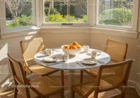 Cozy breakfast nook with oranges and natural light