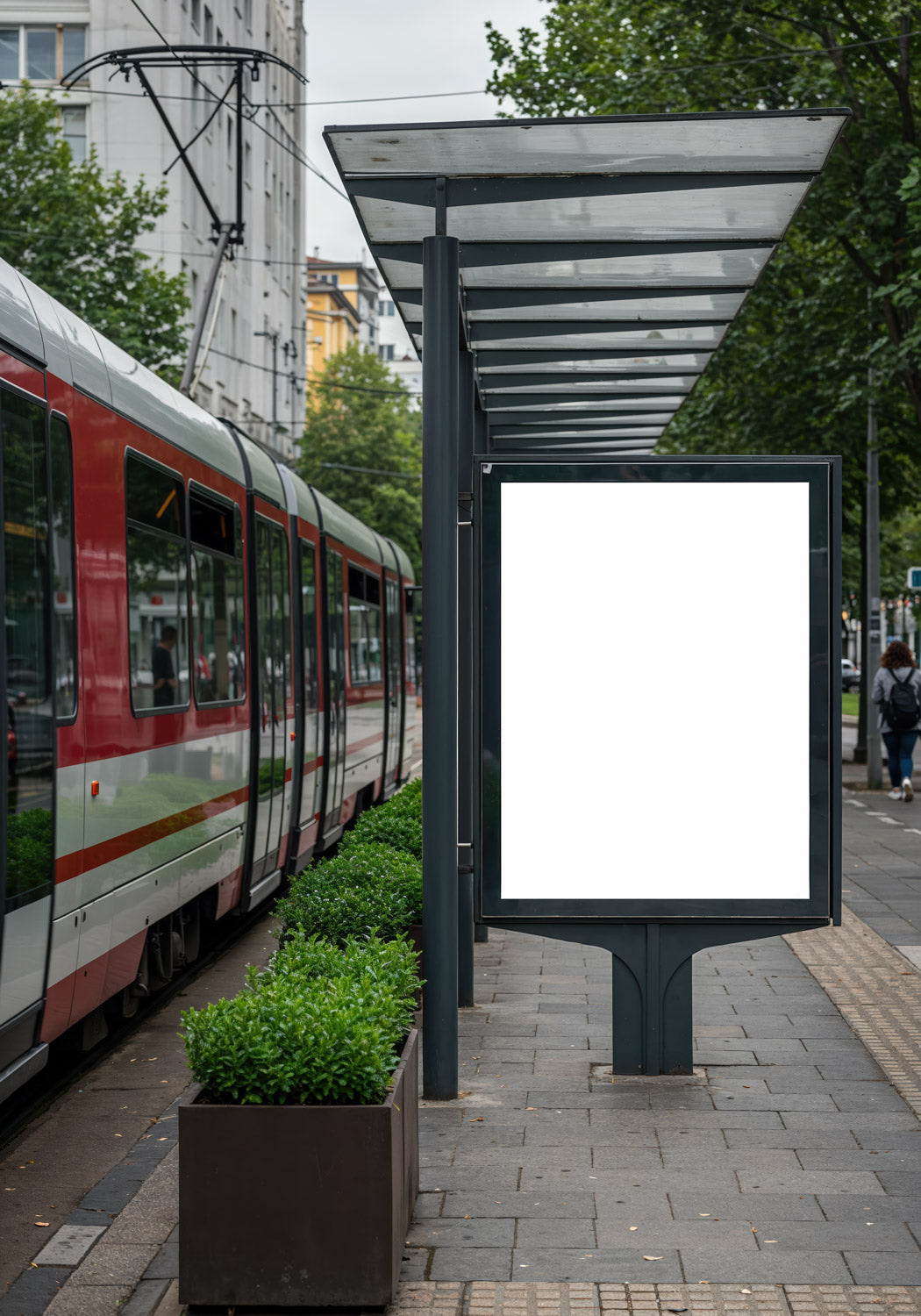 Modern tram station with empty advertising panel in urban setting