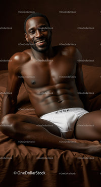 Smiling muscular man relaxing on brown bed linen